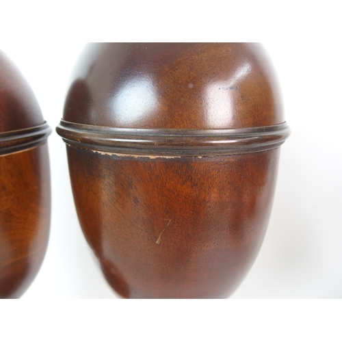 404 - A pair of fluted mahogany urns and covers