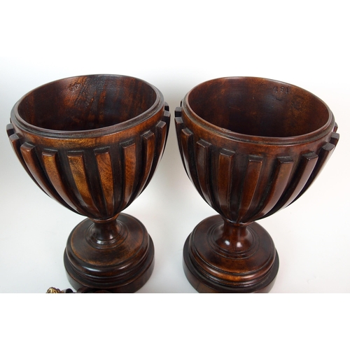 404 - A pair of fluted mahogany urns and covers