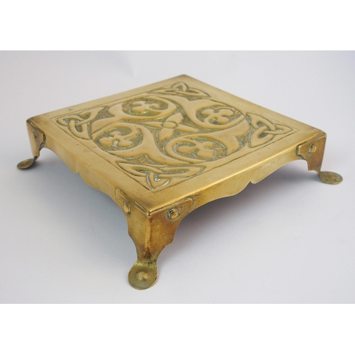 417 - A Celtic revival brass ashtray in the style of Alexander Ritchie