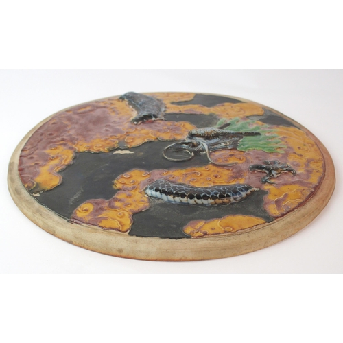 74 - A Chinese fahua style circular moulded pottery plaque