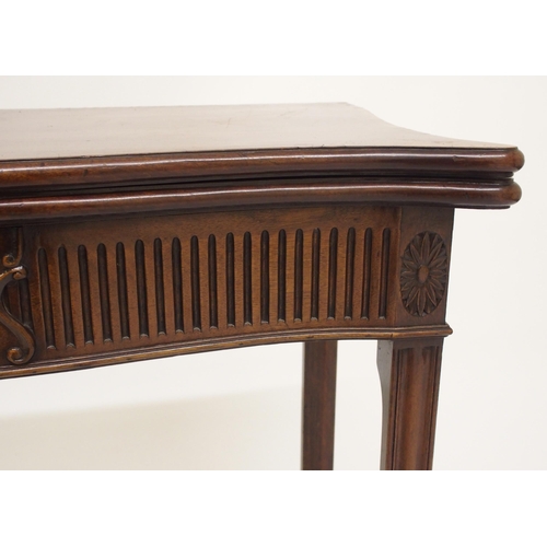 761 - A George III style mahogany serpentine shaped fold over card table