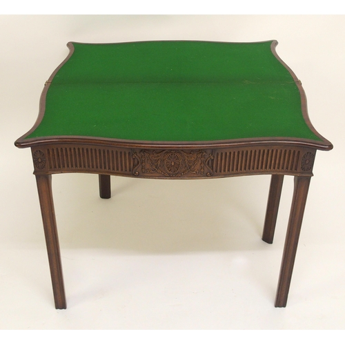 761 - A George III style mahogany serpentine shaped fold over card table