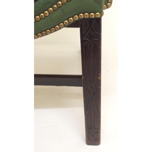 766 - A George III upholstered and brass studded wing armchair