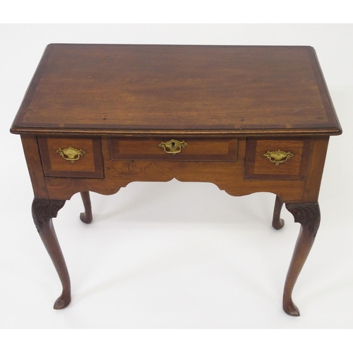 818 - A Georgian crossbanded mahogany and yew lowboy