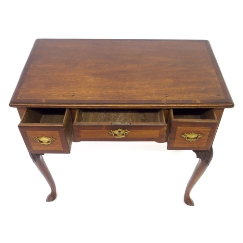 818 - A Georgian crossbanded mahogany and yew lowboy