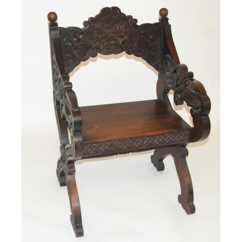 831 - A Celtic pattern carved open armchair