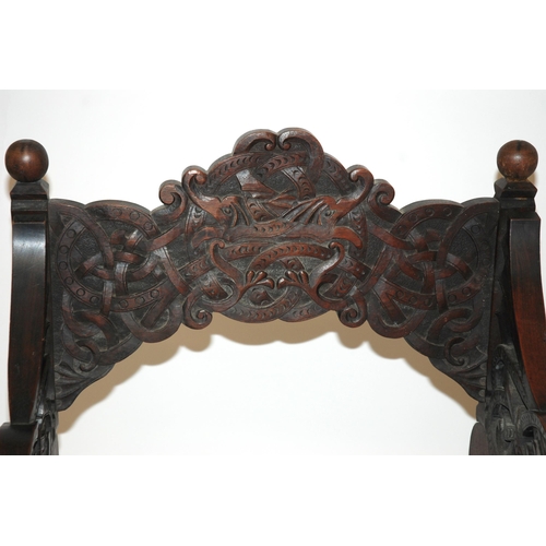 831 - A Celtic pattern carved open armchair