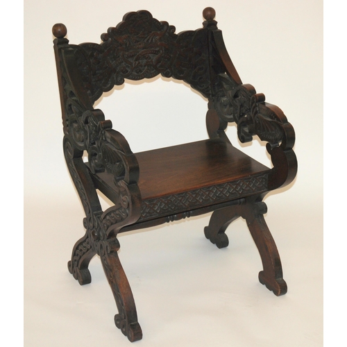 831 - A Celtic pattern carved open armchair