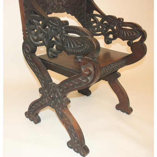 831 - A Celtic pattern carved open armchair