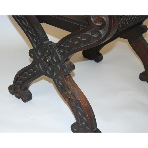 831 - A Celtic pattern carved open armchair