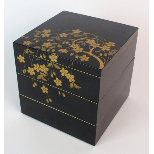 89 - A Japanese black and gold lacquered square three tier box and cover