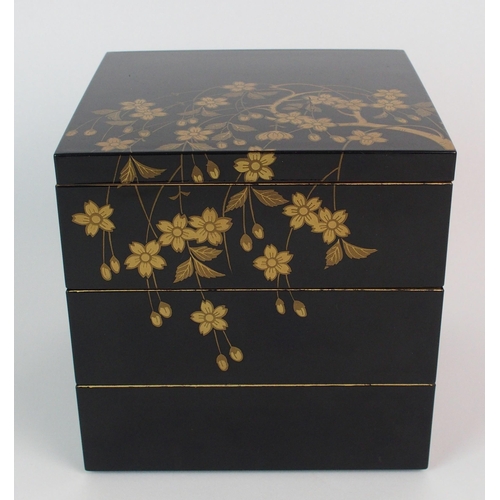 89 - A Japanese black and gold lacquered square three tier box and cover