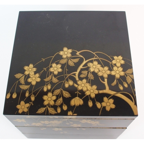 89 - A Japanese black and gold lacquered square three tier box and cover