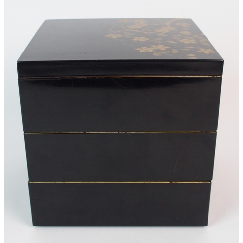 89 - A Japanese black and gold lacquered square three tier box and cover