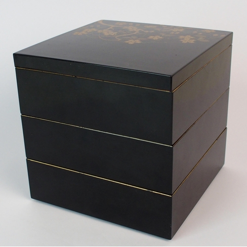 89 - A Japanese black and gold lacquered square three tier box and cover