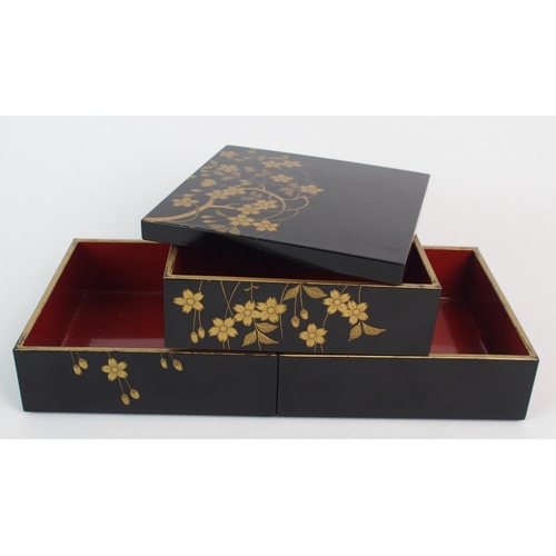 89 - A Japanese black and gold lacquered square three tier box and cover