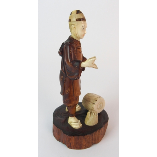 91 - A Japanese carved wood and ivory okimono