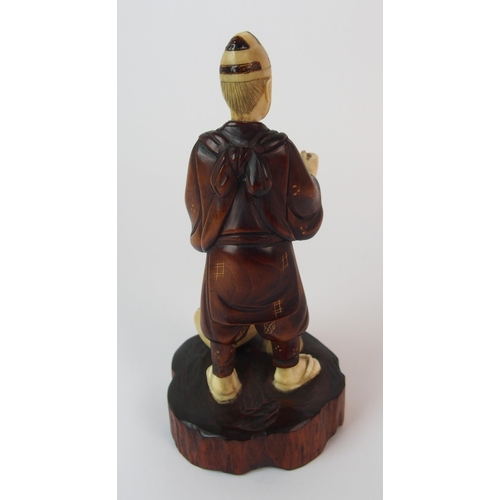 91 - A Japanese carved wood and ivory okimono