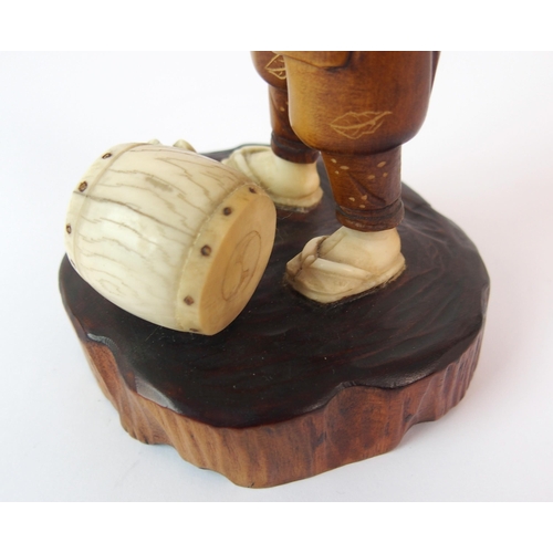 91 - A Japanese carved wood and ivory okimono