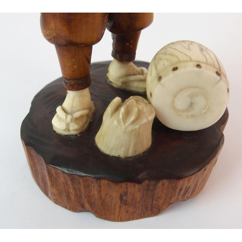 91 - A Japanese carved wood and ivory okimono