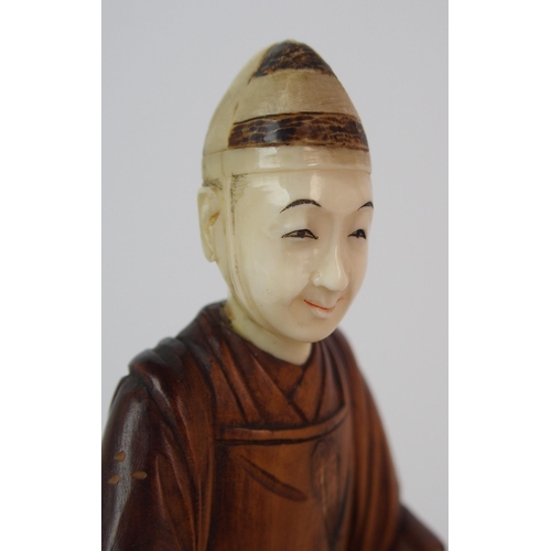 91 - A Japanese carved wood and ivory okimono