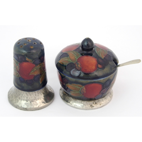 157 - A Moorcroft Pottery Tudric Pomegranate mustard pot and pepper shaker