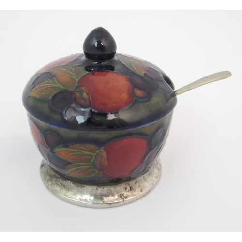 157 - A Moorcroft Pottery Tudric Pomegranate mustard pot and pepper shaker