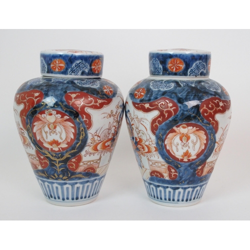 16 - A pair of Imari baluster vases  covers and liners