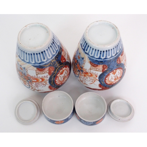 16 - A pair of Imari baluster vases  covers and liners