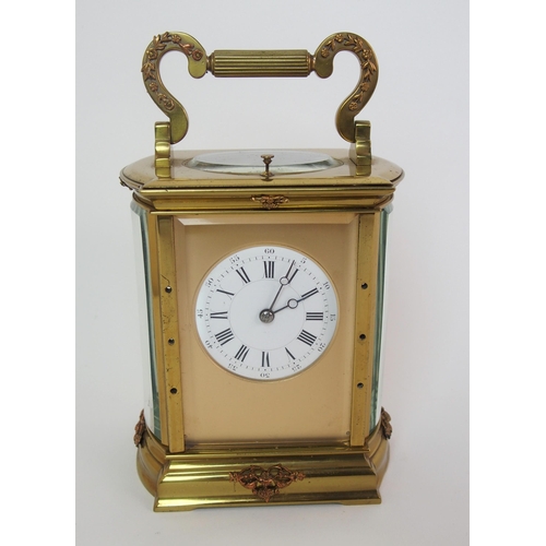 228 - A brass and glass repeater carriage clock