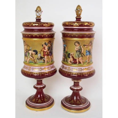 229 - A pair of Viennese painted porcelain footed vases