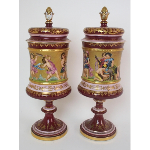 229 - A pair of Viennese painted porcelain footed vases