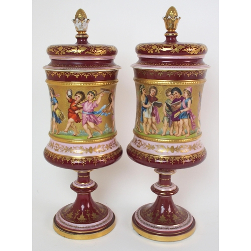 229 - A pair of Viennese painted porcelain footed vases