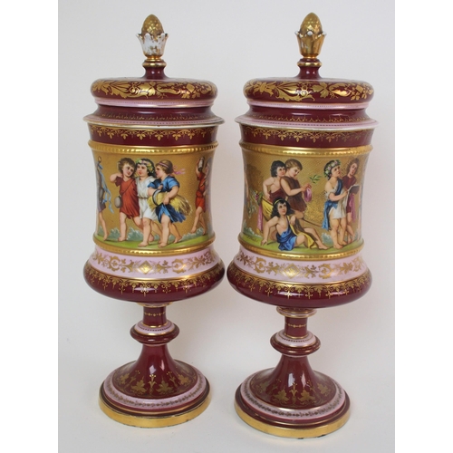 229 - A pair of Viennese painted porcelain footed vases