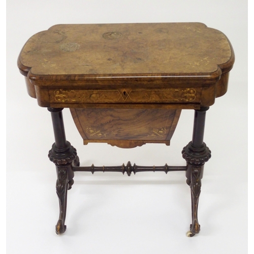 303 - A Victorian walnut inlaid games and sewing table