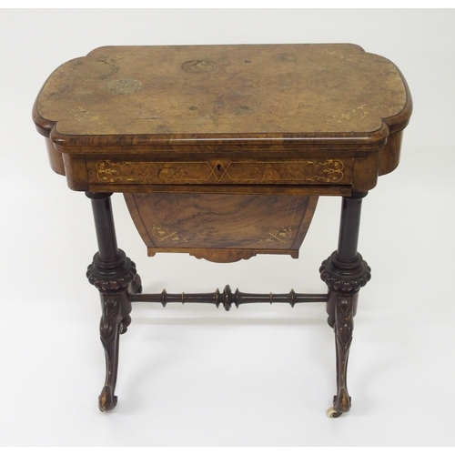 303 - A Victorian walnut inlaid games and sewing table