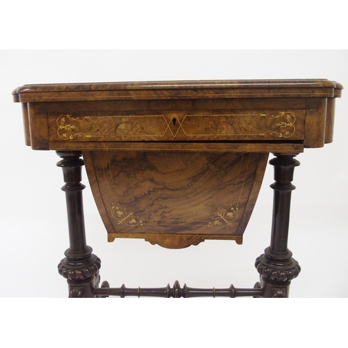 303 - A Victorian walnut inlaid games and sewing table