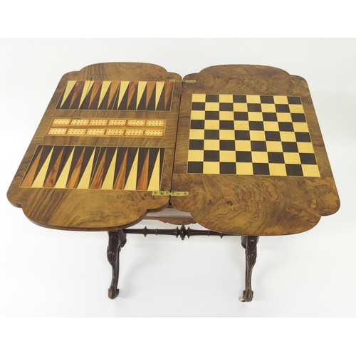 303 - A Victorian walnut inlaid games and sewing table