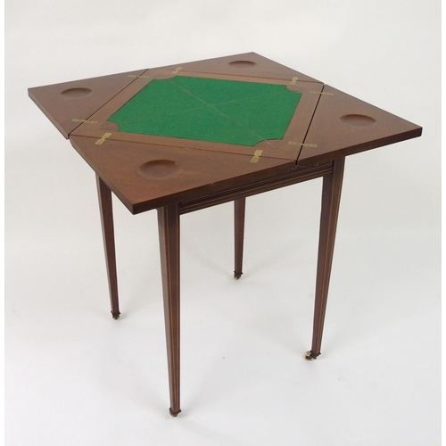 306 - An Edwardian mahogany and crossbanded envelope card table