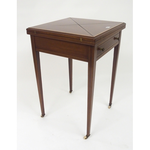 306 - An Edwardian mahogany and crossbanded envelope card table