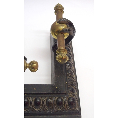 370 - A Victorian cast iron and brass fender