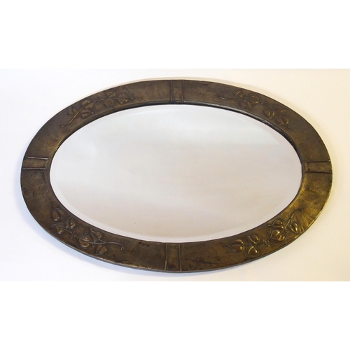 371 - An Arts and Crafts oxidised copper oval wall mirror