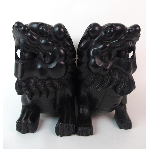 68 - A pair of Chinese ebonised dogs of Fo