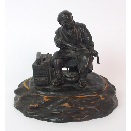 74 - A Japanese bronze of an itinerant worker