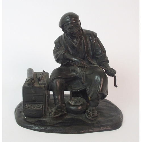 74 - A Japanese bronze of an itinerant worker