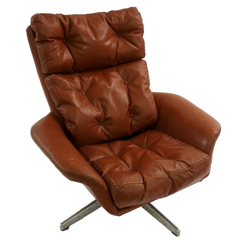 1006 - A 1960's brown leather button back swivel chair