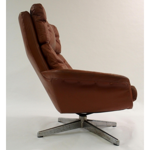 1006 - A 1960's brown leather button back swivel chair