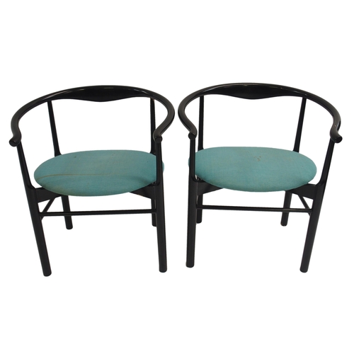 1007 - A pair of black Danish armchairs