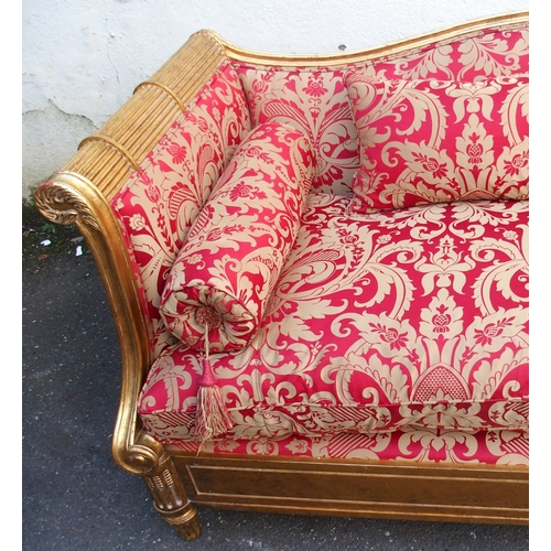 1018 - A modern gilt framed Reims sofa