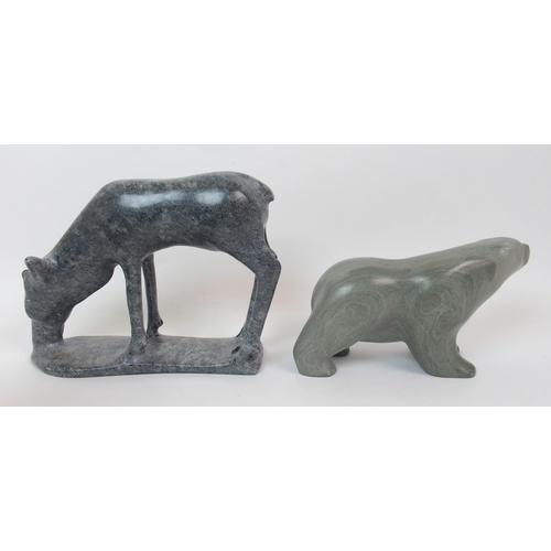 17 - An Inuit hardstone carving on a man seated with his dog